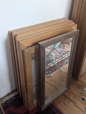 Lot 615 - A suite of seven light oak framed wall mirrors,...