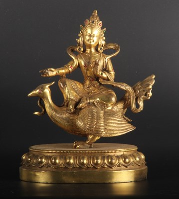 Lot 133 - An Asian gilt bronze figure of a deity, shown...
