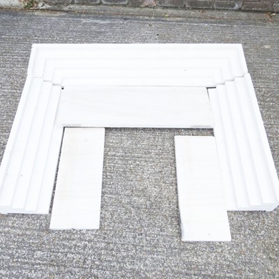 Lot 387 - A travertine fire surround, in sections, 132cm...