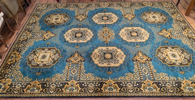 Lot 546 - A large Persian style rug, having a blue and...