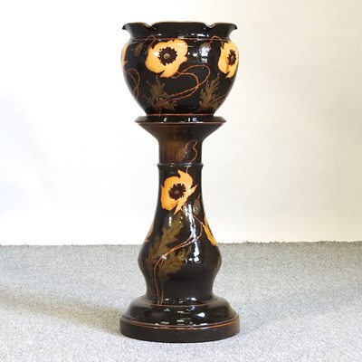 Lot 228 - An early 20th century brown glazed pottery jardinière on stand