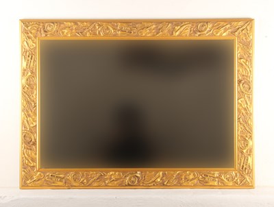 Lot 758 - A large gilt framed bevelled mirror, relief...