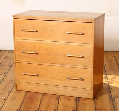 Lot 235 - Ernest Gomme, an oak chest of three long...