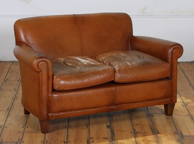 Lot 351 - A brown leather upholstered two seater sofa