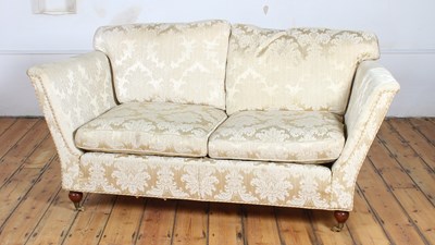 Lot 225 - A cream silk damask two seater sofa, on turned...
