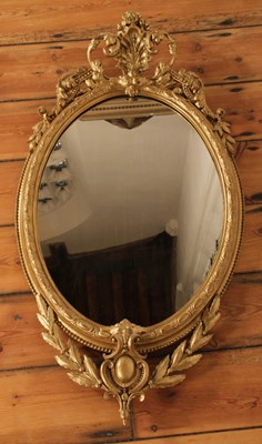 Lot 70 - A 19th century ornate gilt framed oval wall...