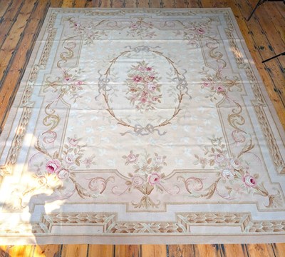 Lot 380 - An Aubusson rug, decorated with pink roses...
