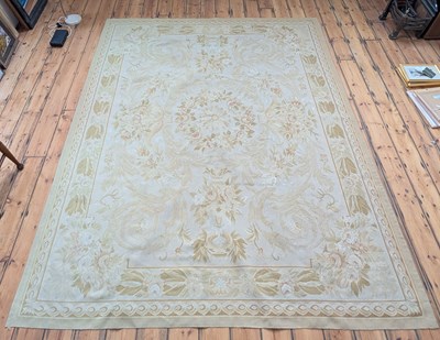 Lot 506 - An Aubusson rug, decorated with flowers on a...