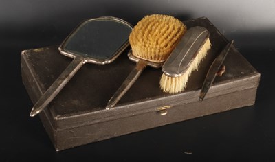 Lot 84 - A George V four piece silver backed dressing...