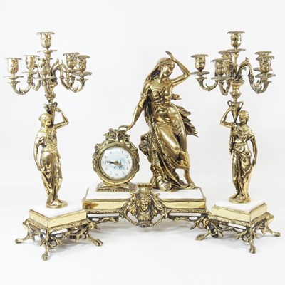 Lot 421 - A continental gilt metal three piece clock...