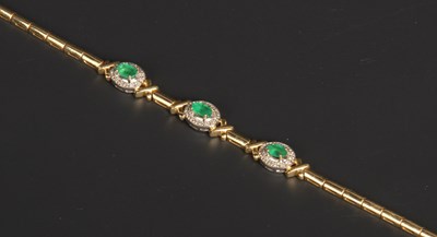 Lot 8 - A 14 carat yellow gold emerald and diamond...