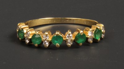 Lot 80 - A 9 carat yellow gold seventeen stone emerald...