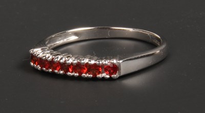 Lot 92 - A 9 carat white gold sunset sapphire channel...