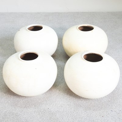 Lot 210 - A set of four Eastern cream glazed vases, 33cm...