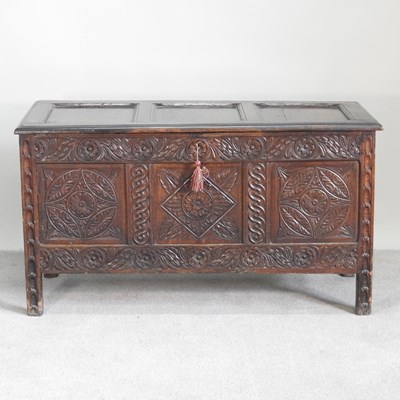 Lot 375 - An 18th century panelled oak coffer, with a...