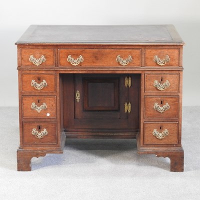 Lot 7 - An early 20th century walnut kneehole desk,...