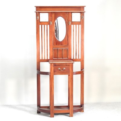 Lot 355 - A modern hardwood mirror back hallstand, with...