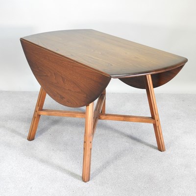 Lot 105 - A mid 20th century Ercol drop leaf dining...