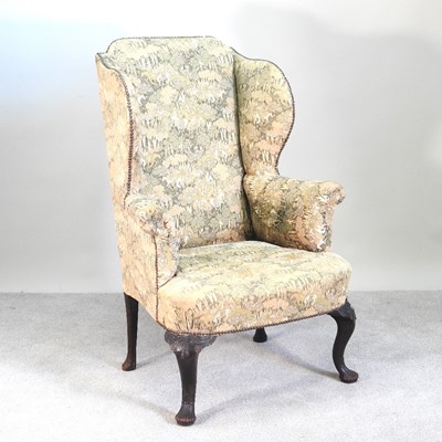 Lot 169 - An early 20th century green upholstered wing...