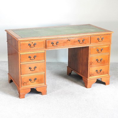 Lot 337 - A reproduction yew wood pedestal desk, with an...
