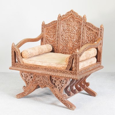 Lot 130 - An Eastern carved hardwood elephant howdah...
