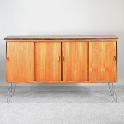 Lot 42 - A 1970s teak sideboard, with sliding doors, on...
