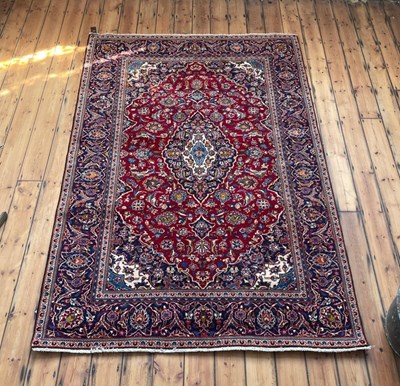 Lot 25 - A Persian kashan carpet, on a red ground, 290...