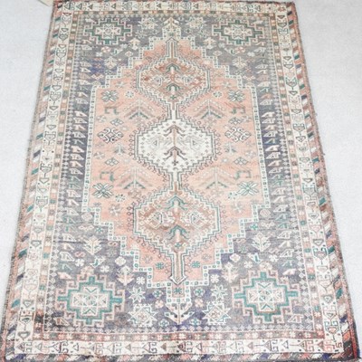 Lot 387 - A Persian shiraz rug, in a red ground, 210 x...