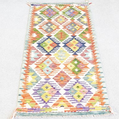 Lot 34 - A kilim runner, with all over coloured...