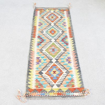 Lot 133 - A kilim runner, with a row of four central...