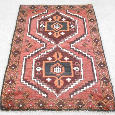 Lot 521 - A baluchi rug, with two central hooked...