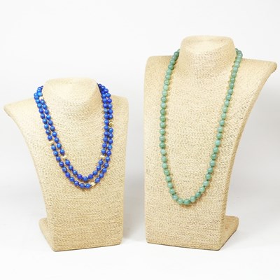 Lot 260 - A lapis and gilt single strand bead necklace,...