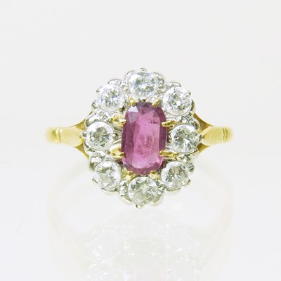 Lot 26 - An 18 carat gold ruby and diamond cluster ring,...