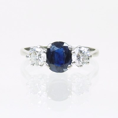 Lot 176 - A sapphire and diamond three stone ring, the...