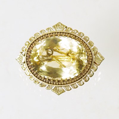 Lot 4 - A large citrine brooch, the central oval cut...