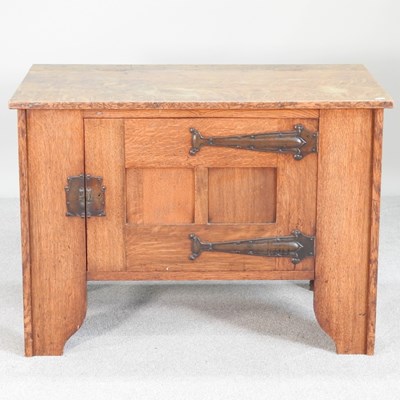 Lot 378 - An Arts and Crafts light oak cabinet, with a...