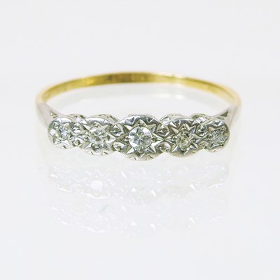 Lot 198 - A large 18 carat gold illusion set five stone...