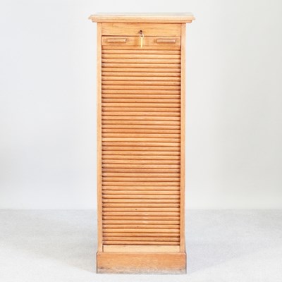 Lot 239 - An early 20th century light oak tambour front...