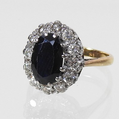 Lot 70 - An unmarked sapphire and diamond cluster ring
