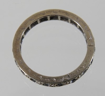 Lot 44 - An unmarked full hoop eternity ring