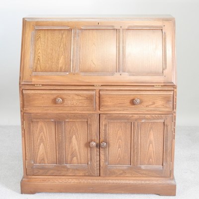 Lot 447 - An Ercol elm bureau, with cupboards below