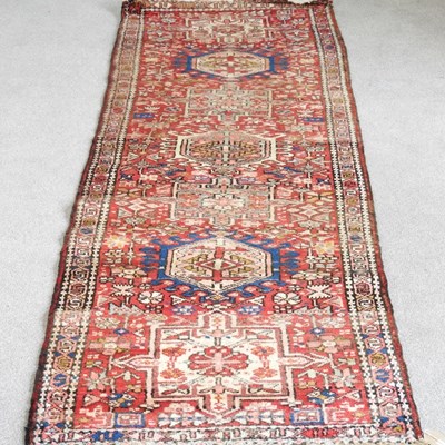 Lot 446 - A Persian runner, with a row of central hooked...
