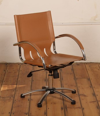 Lot 496 - A brown upholstered and metal swivel desk chair