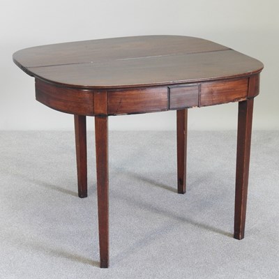 Lot 481 - A George III mahogany folding tea table, on...
