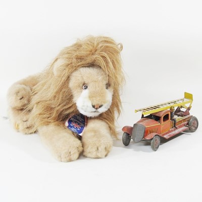 Lot 424 - A plush toy lion, together with a fire engine (2)