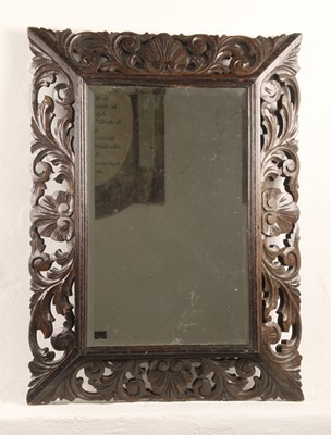 Lot 645 - A Victorian carved oak bevelled mirror, the...