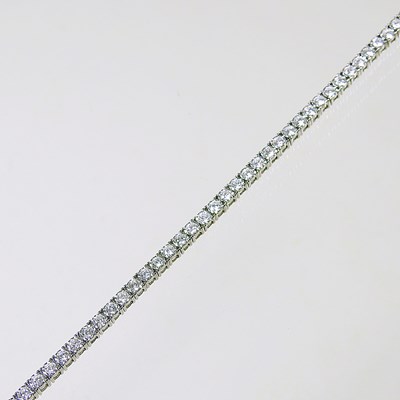 Lot 173 - A diamond tennis bracelet, set with a...
