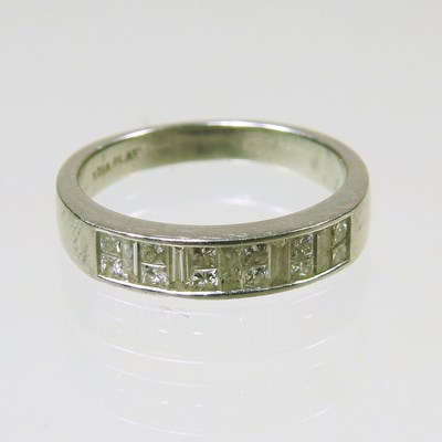 Lot 244 - A platinum and diamond half hoop eternity ring,...