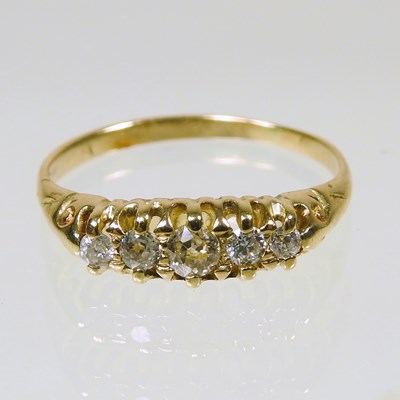 Lot 312 - An 18 carat gold diamond ring, set with a row...