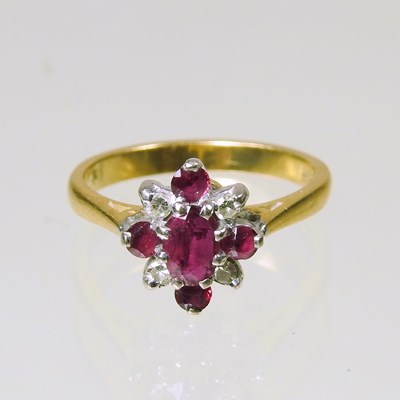 Lot 315 - An 18 carat gold ruby and diamond cluster ring,...